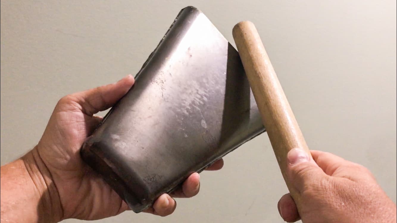 cowbell held in hand and struck with stick for cowbell song article