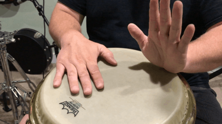 wrist is resting on the drum with fingers pointing straight up in preparation for toe stroke on the conga head